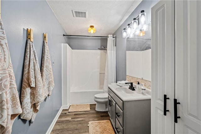 115 Donna Dr, Dawsonville, GA 30534 - bathroom featuring vanity, wood finished floors, shower / bath combo, and a textured ceiling