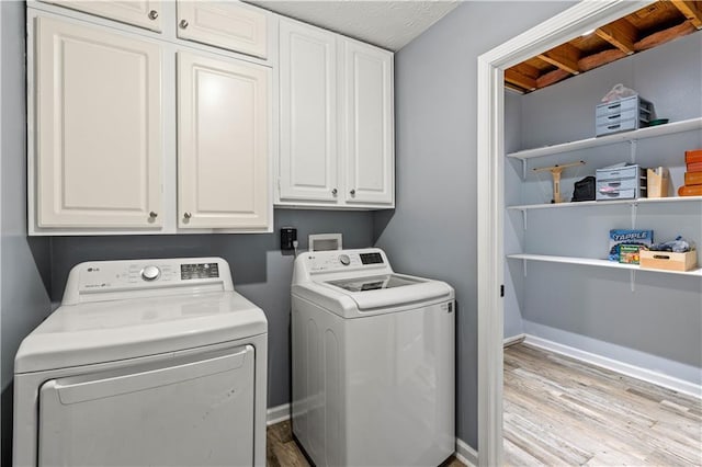 115 Donna Dr, Dawsonville, GA 30534 - washroom featuring washing machine and dryer, wood finished floors, and cabinet space