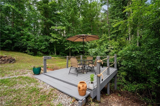 115 Donna Dr, Dawsonville, GA 30534 - deck featuring outdoor dining area, a yard, and a view of trees