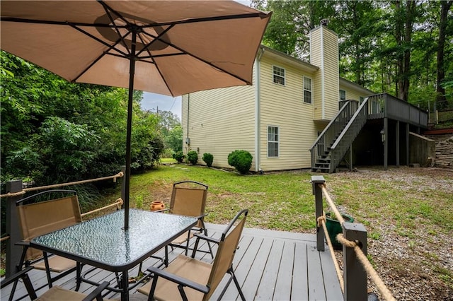 115 Donna Dr, Dawsonville, GA 30534 - wooden deck with stairway, a lawn, and outdoor dining space