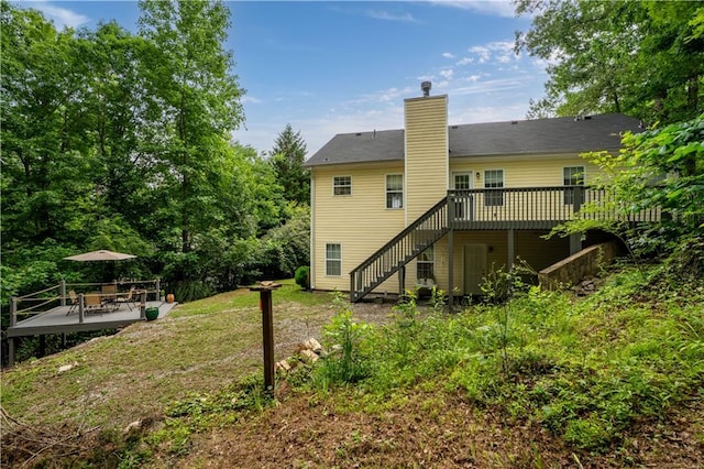 115 Donna Dr, Dawsonville, GA 30534 - rear view of property featuring stairway, a wooden deck, a chimney, and a patio