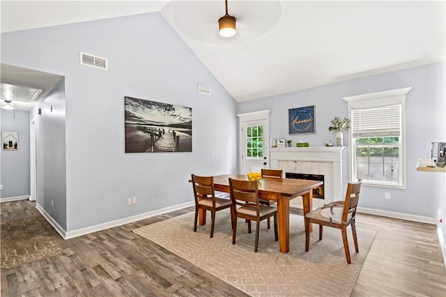 115 Donna Dr, Dawsonville, GA 30534 - dining area with attic access, wood finished floors, a ceiling fan, high vaulted ceiling, and a premium fireplace