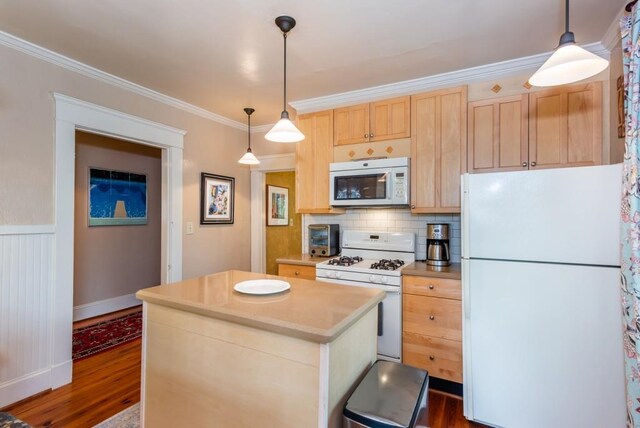 kitchen with dark hardwood / wood-style floors, white appliances, decorative light fixtures, ornamental molding, and light brown cabinetry