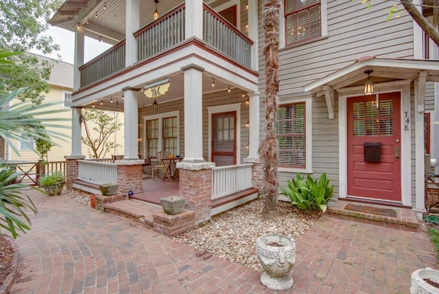 property entrance featuring a balcony and a patio