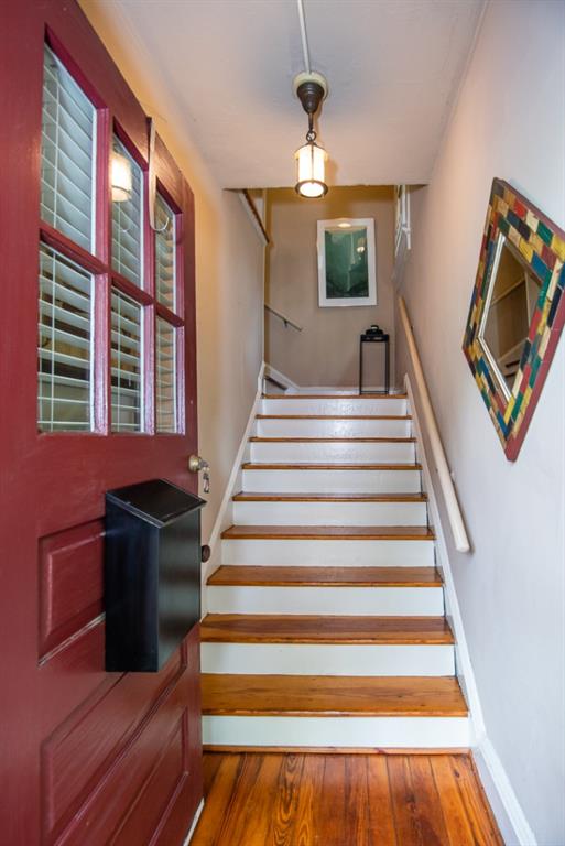 staircase with hardwood / wood-style flooring