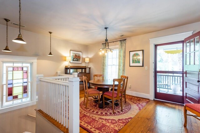 dining room with a notable chandelier and hardwood / wood-style flooring