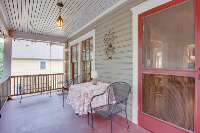 sunroom featuring wood ceiling