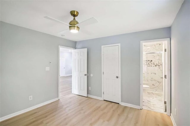 unfurnished bedroom with light hardwood / wood-style flooring, ceiling fan, a closet, and ensuite bath