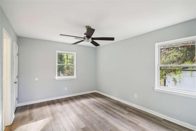 empty room featuring hardwood / wood-style floors and ceiling fan