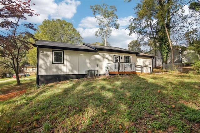 back of house with a yard and a wooden deck