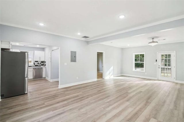 unfurnished living room featuring ceiling fan, ornamental molding, electric panel, and light wood-type flooring