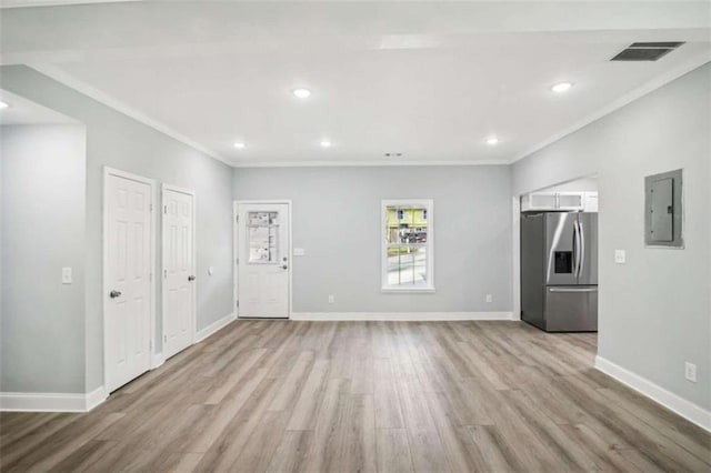 unfurnished living room with electric panel, crown molding, and light hardwood / wood-style floors