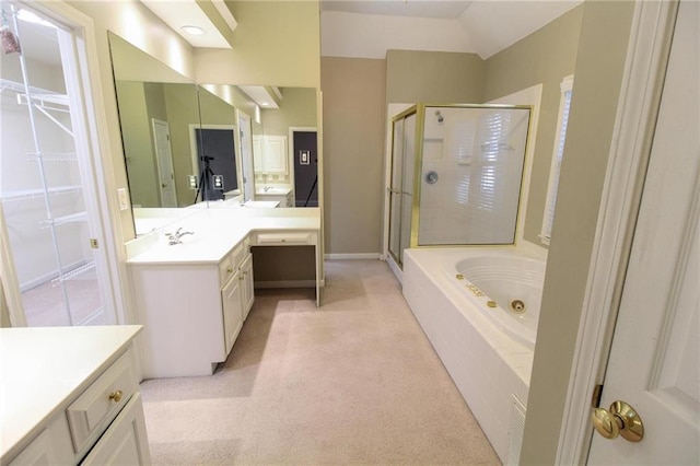 bathroom with a stall shower, a whirlpool tub, baseboards, vaulted ceiling, and vanity