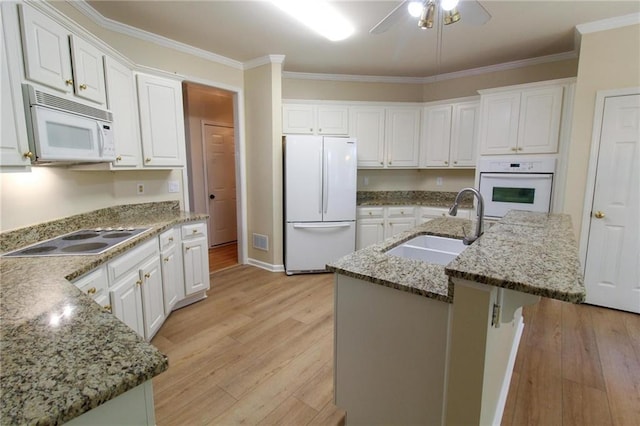 kitchen featuring a sink, white appliances, ornamental molding, a ceiling fan, and light wood-style floors