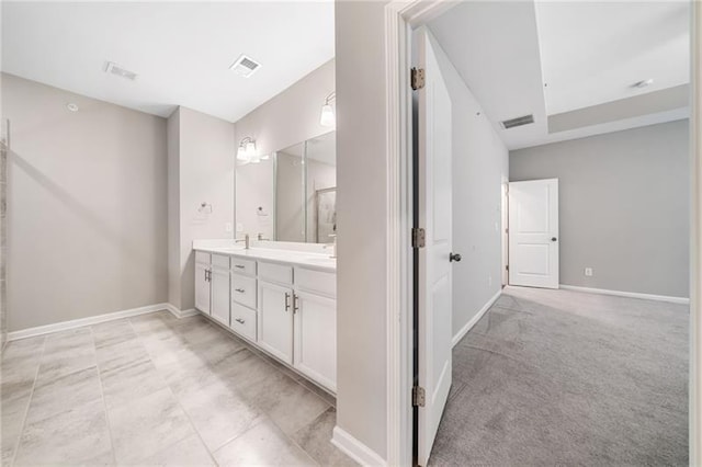 full bathroom featuring double vanity and baseboards