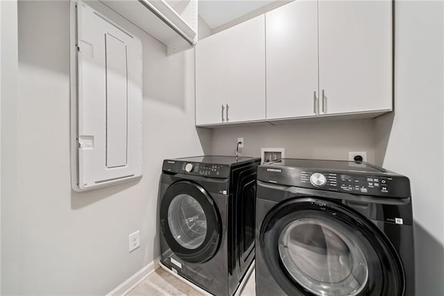washroom with independent washer and dryer, cabinet space, and baseboards