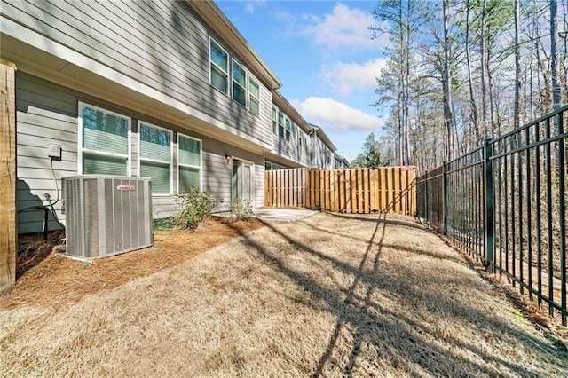 view of yard with cooling unit and fence