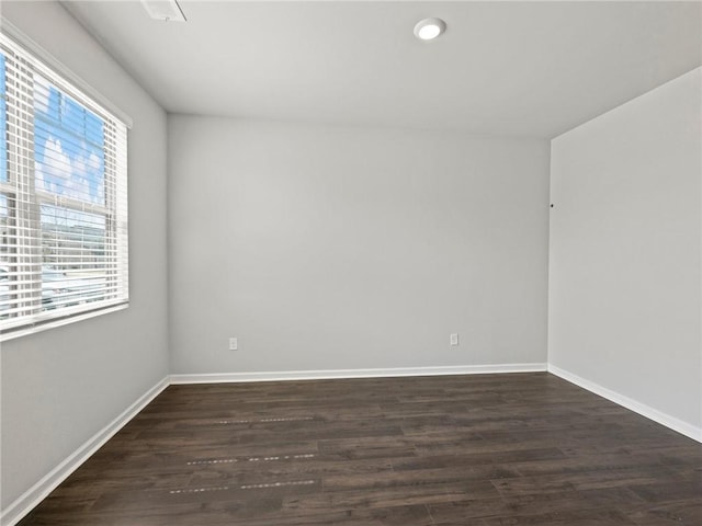 unfurnished room with baseboards, dark wood-style flooring, and recessed lighting