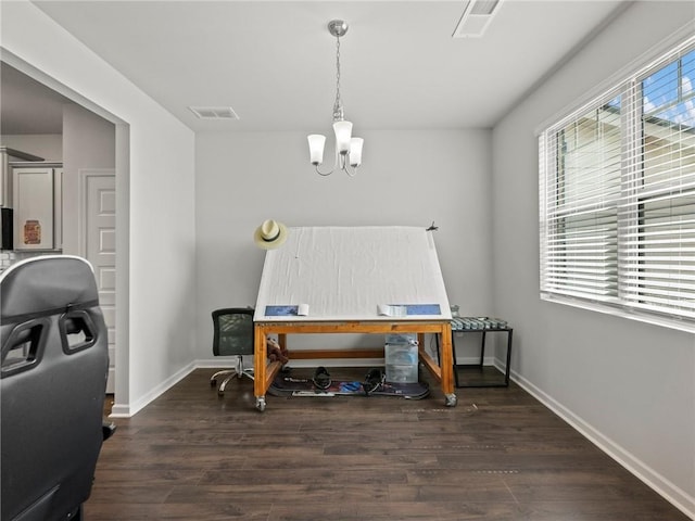 office area with a chandelier, wood finished floors, visible vents, and baseboards