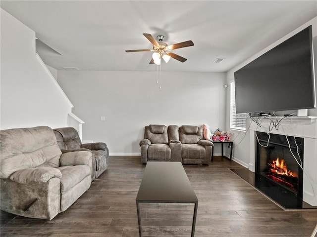 living room with ceiling fan, baseboards, dark wood-style flooring, and visible vents