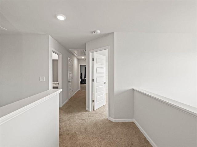 hallway with attic access, baseboards, recessed lighting, an upstairs landing, and light colored carpet