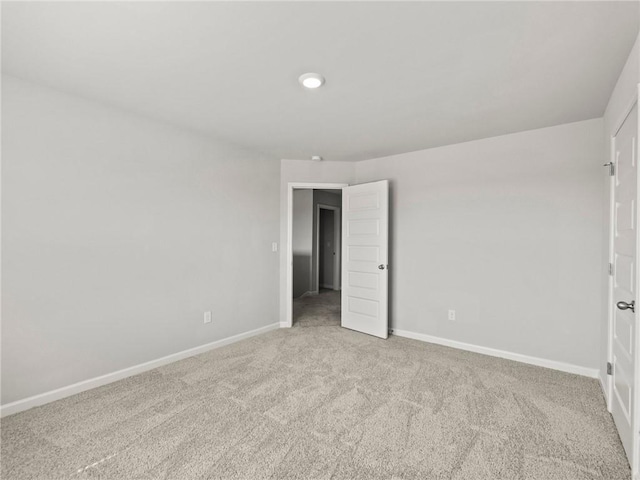 unfurnished bedroom with baseboards and carpet flooring