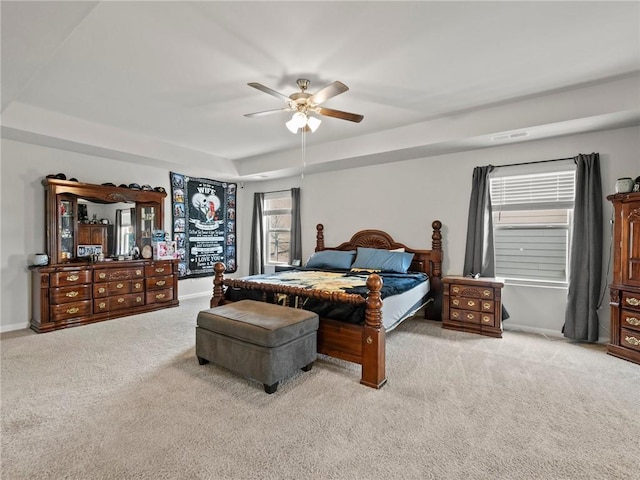 bedroom with carpet floors, visible vents, a ceiling fan, and baseboards