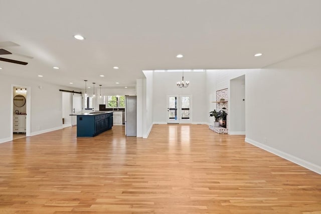 unfurnished living room featuring light wood finished floors and recessed lighting