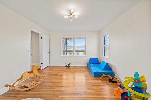 living area with baseboards and light wood finished floors