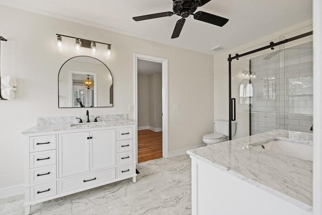 bathroom with marble finish floor, a stall shower, and vanity