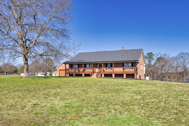 back of property with a lawn and brick siding