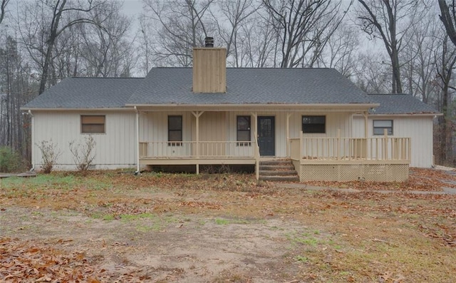 rear view of property featuring a porch