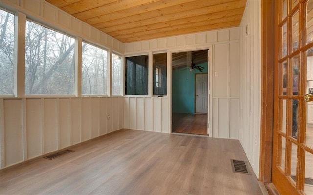 unfurnished sunroom with wood ceiling