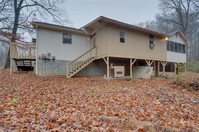 rear view of property featuring a sunroom