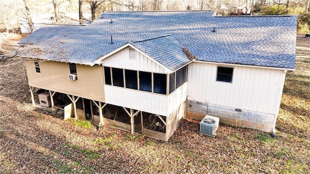 back of property with a sunroom and central air condition unit