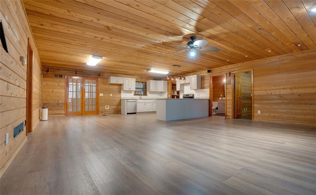 unfurnished living room with wooden ceiling, french doors, wooden walls, ceiling fan, and wood-type flooring