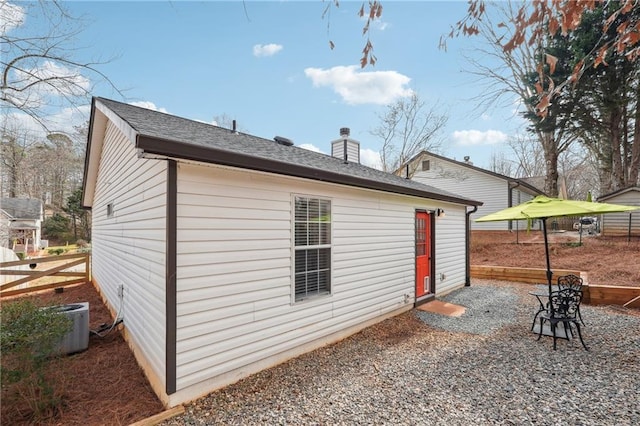 rear view of property featuring central AC unit