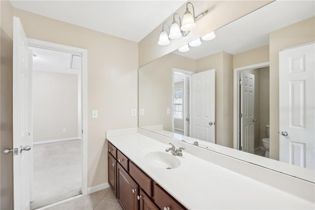 bathroom featuring vanity, toilet, and tile patterned flooring