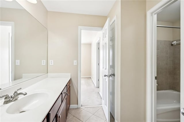 bathroom featuring tile patterned flooring, vanity, and tiled shower / bath combo