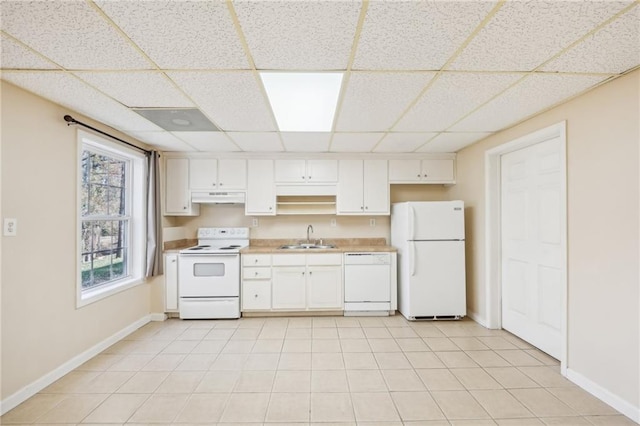 kitchen featuring a drop ceiling, sink, white appliances, and white cabinets