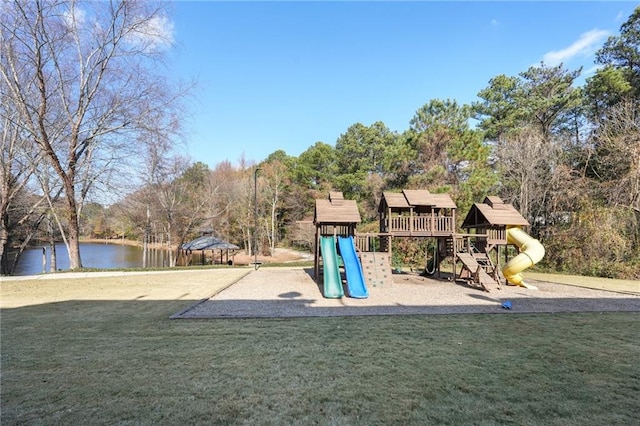 view of jungle gym featuring a water view and a yard