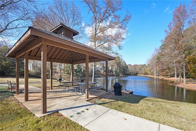 view of community featuring a gazebo, a water view, and a yard