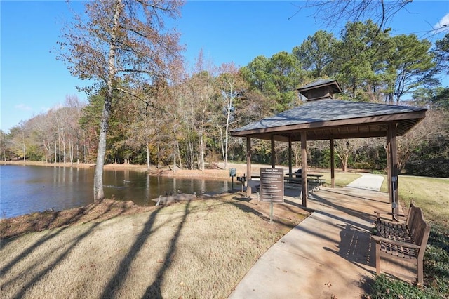 surrounding community featuring a gazebo, a lawn, and a water view