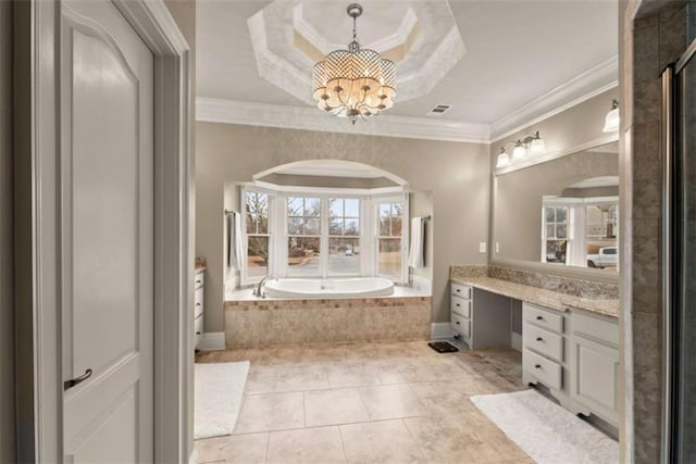 bathroom featuring tiled tub, crown molding, vanity, tile patterned floors, and a raised ceiling