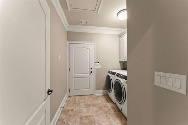 laundry room with cabinets, washing machine and dryer, and ornamental molding