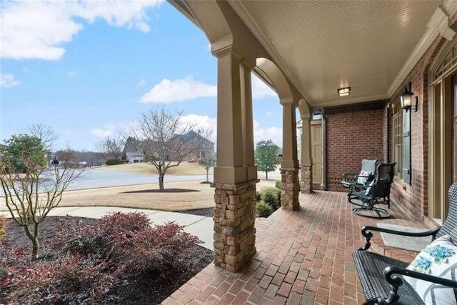 view of patio featuring a water view and a porch