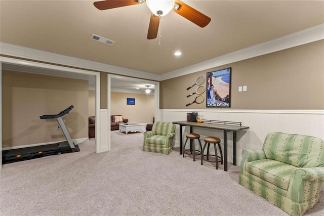 interior space with crown molding, carpet flooring, and ceiling fan