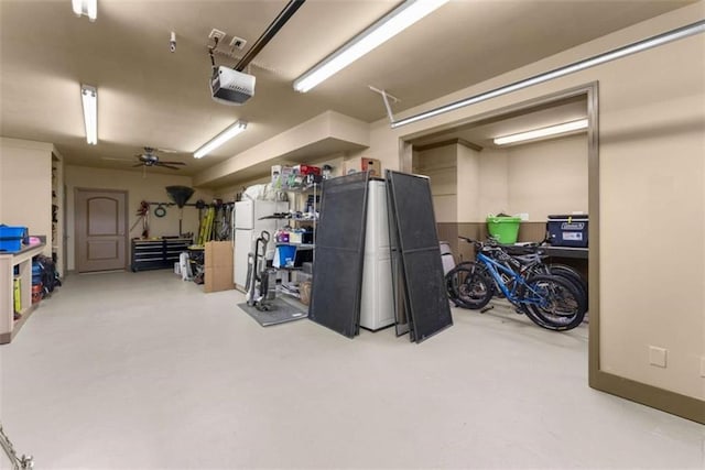 garage with a garage door opener and ceiling fan