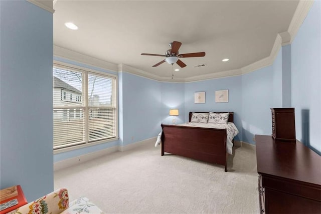 bedroom with crown molding, light colored carpet, and ceiling fan