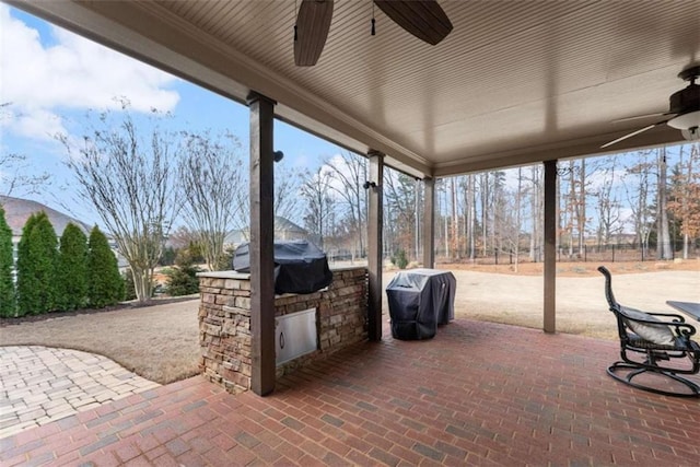 view of patio featuring ceiling fan, area for grilling, and grilling area